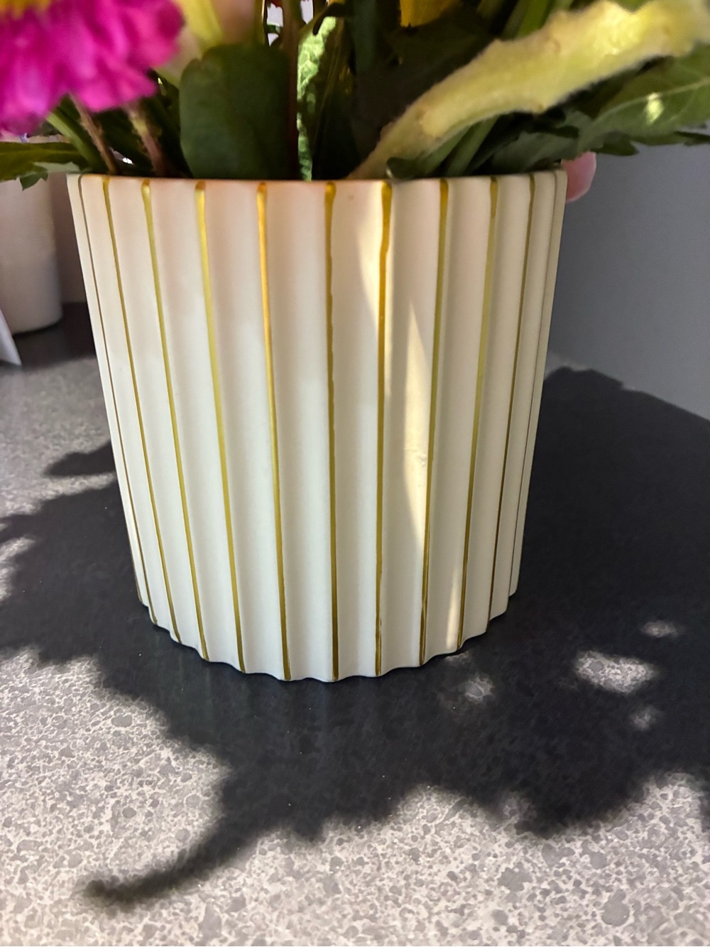 Vase circular with vertical lines.  white with gold accent stripes